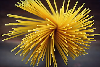 Top-down view of raw spaghetti pasta arranged in a starburst pattern