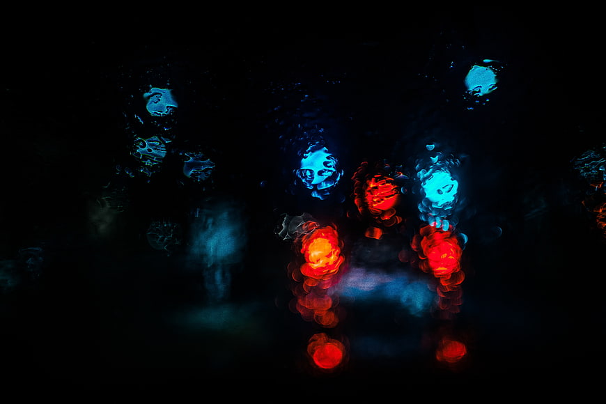 Abstract Bokeh Lights on Rainy Window at Night
