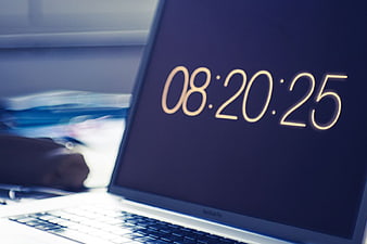 Laptop Screen Displaying Digital Clock Time