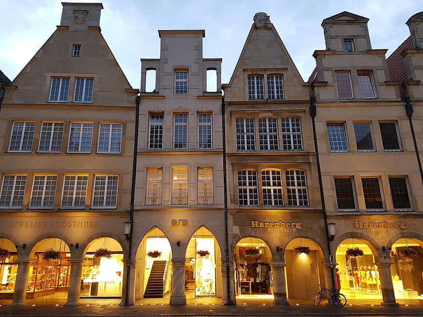 Historic European Architecture with Illuminated Shop Windows at Dusk