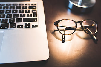 Laptop and Glasses on Wooden Desk