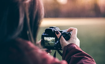 Woman Photographing Scenery with DSLR Camera