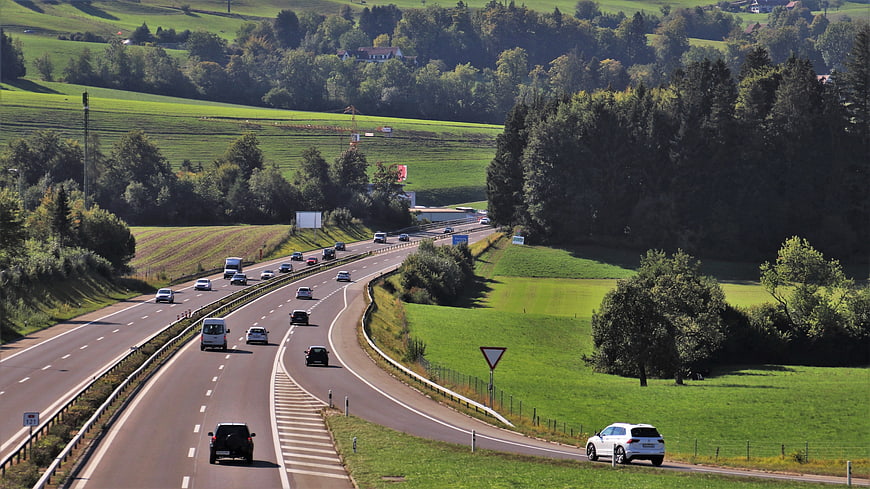 Highway Traffic Through Green Countryside Landscape