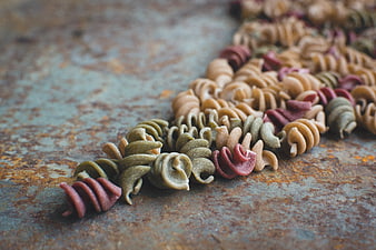 Colorful Fusilli Pasta on Rusty Metal Surface