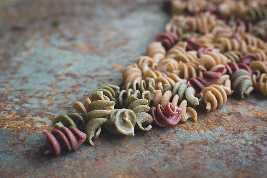 Colorful Fusilli Pasta on Rusty Metal Surface