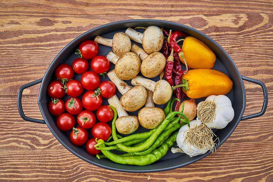 Fresh Vegetables in Black Pan on Wooden Table