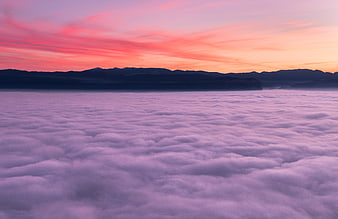 Vibrant Pink and Purple Sunset Over Sea of Clouds
