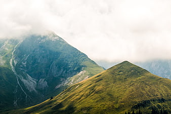 Misty Green Mountain Peaks in the Swiss Alps
