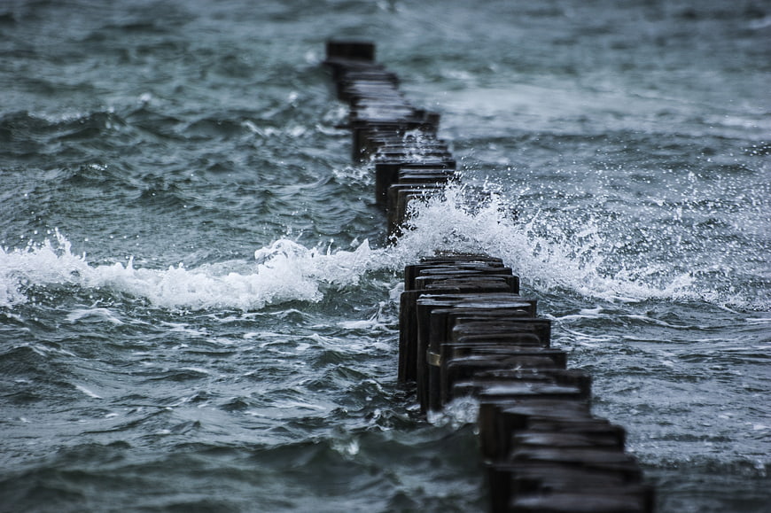 Wooden Groyne Pier in Rough Ocean Waves