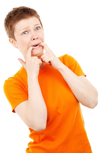 Scared Woman Biting Fingernails in Orange Shirt