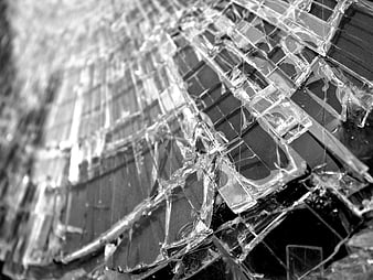 Close-up of shattered glass texture with sharp cracks and fragments
