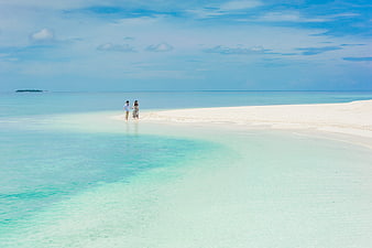 Couple Walking On White Sandbar In Turquoise Maldives Lagoon