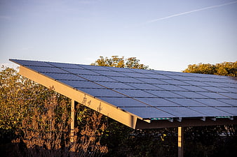 Solar Panel Array on Metal Frame Against Blue Sky