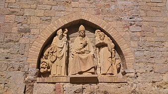 Ancient Stone Religious Sculpture on Church Facade