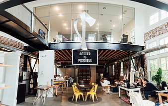 Modern industrial office interior with loft and collaborative workspace