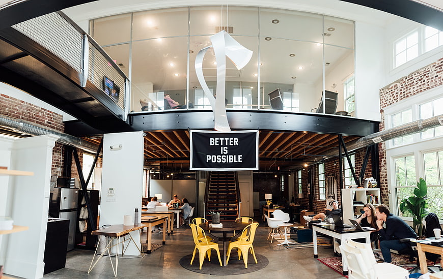 Modern industrial office interior with loft and collaborative workspace