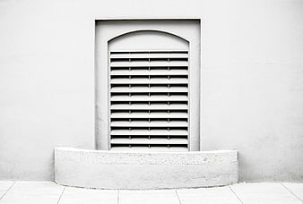 Minimalist White Window with Louvers on Textured Wall