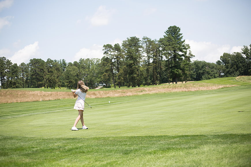 Woman Golfing on Green Course