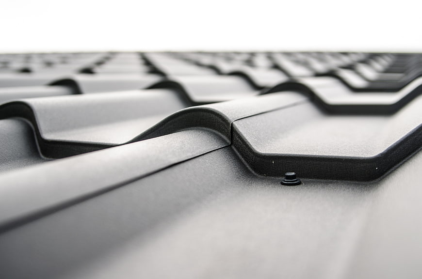 Close-up of black corrugated roof tiles with shallow depth of field
