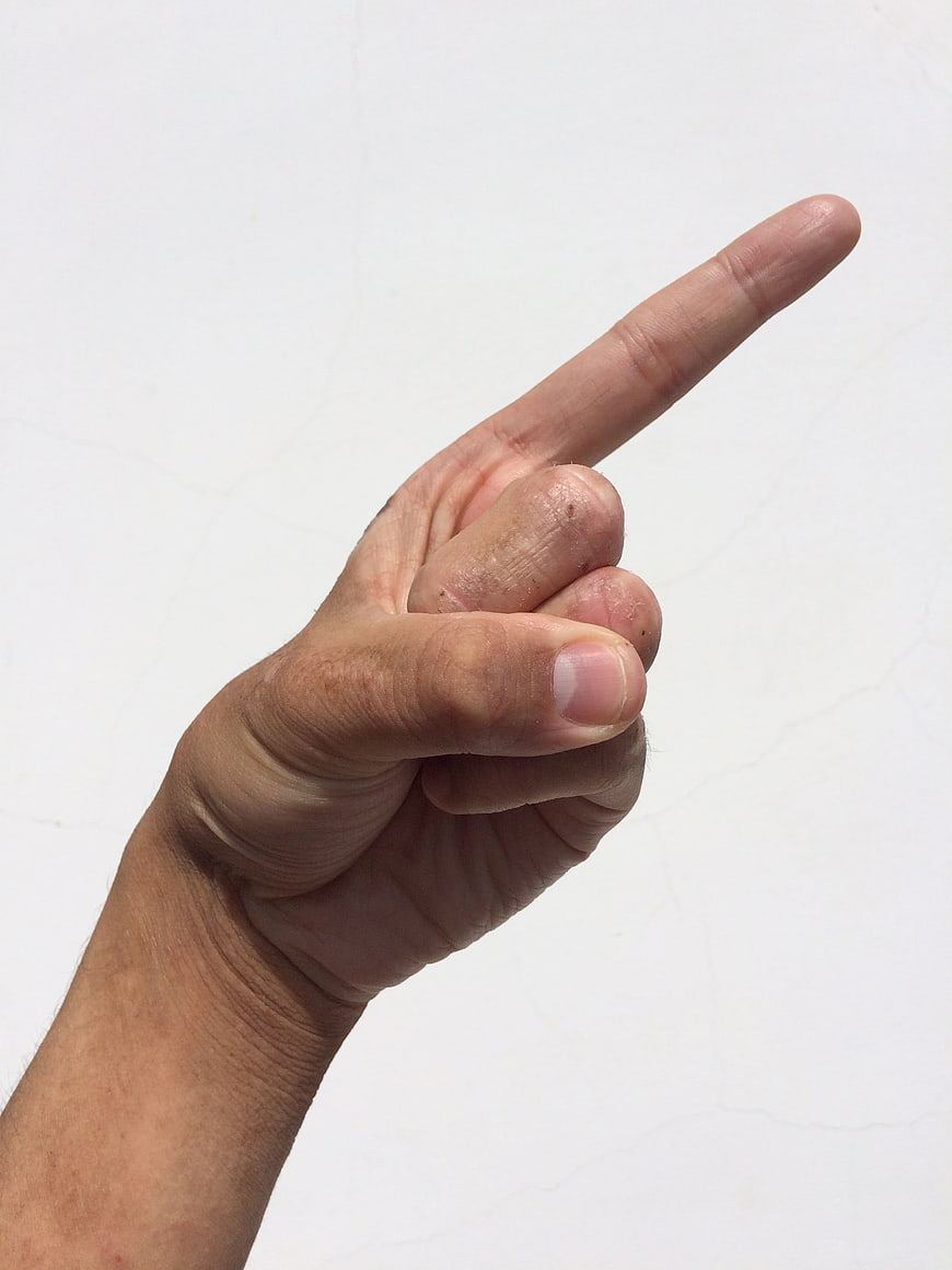 Hand Pointing Finger Up Against White Background