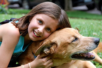 Happy Girl Hugging Golden Retriever Dog Outdoors