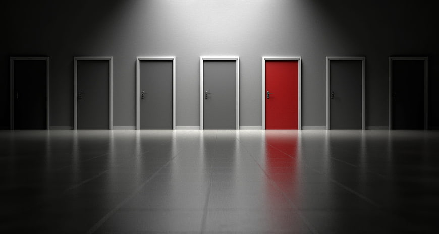 Conceptual 3D Render of Red Door Among Gray Doors in Dark Hallway