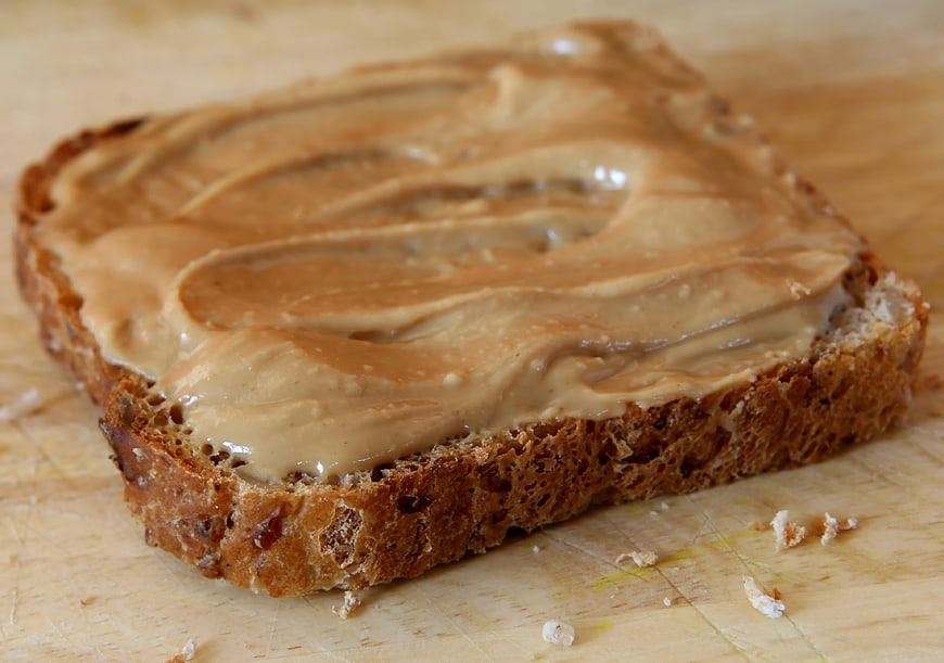 Close-up of peanut butter spread on whole wheat bread