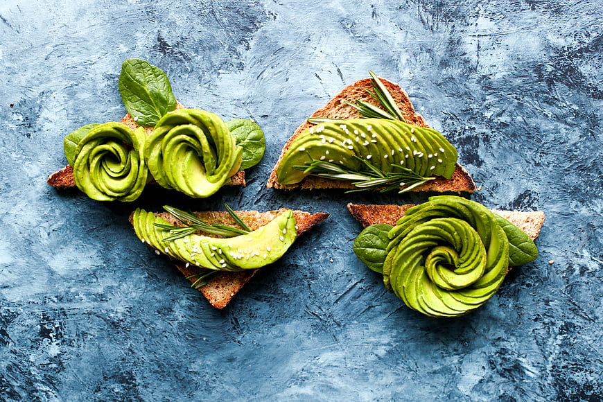 Avocado Rose Toasts on Blue Textured Background