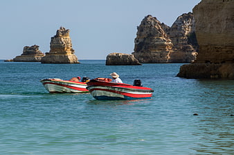 Traditional Portuguese Fishing Boats Near Coastal Cliffs