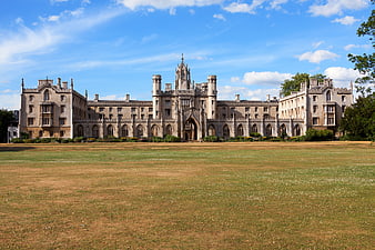 Historic Gothic University College Building With Large Green Lawn