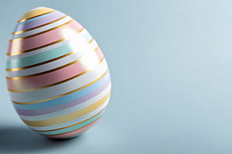 Pastel Easter Egg with Gold Stripes on Blue Background