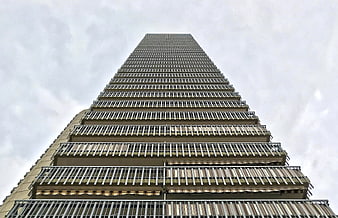 Low angle view of tall apartment building with balconies
