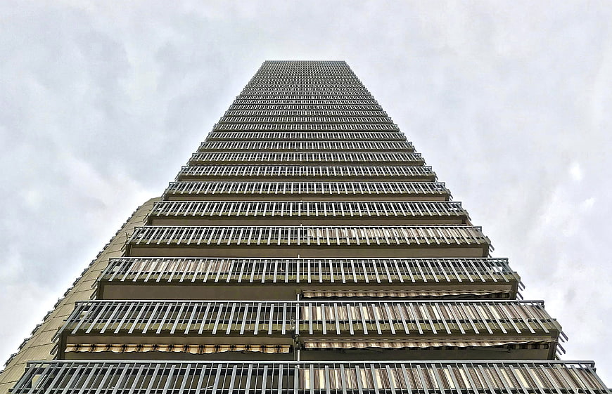 Low angle view of tall apartment building with balconies