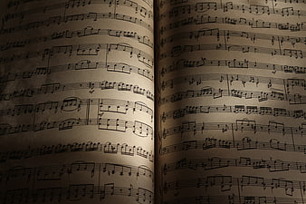 Close-up of vintage sheet music with dramatic lighting