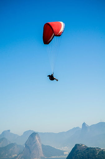 Paraglider soaring over Rio de Janeiro mountains