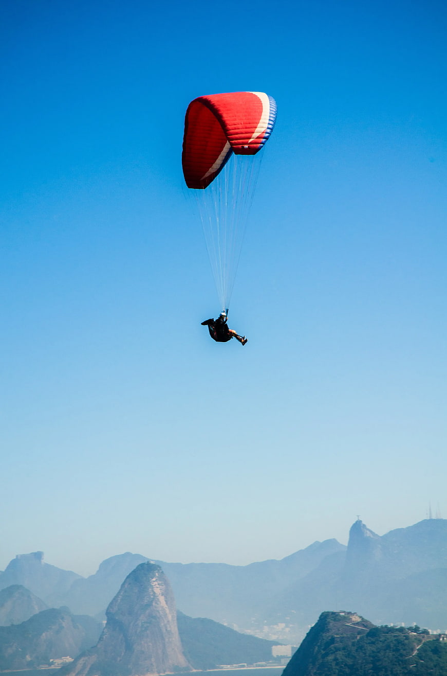 Paraglider soaring over Rio de Janeiro mountains