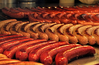 Grilled Sausages Arranged In Rows On A Hot Griddle