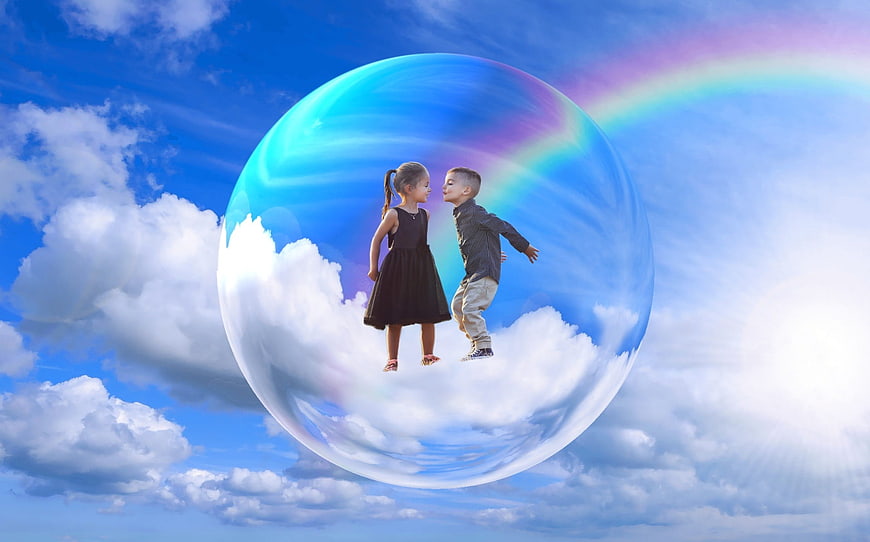 Two children inside a giant soap bubble in the sky