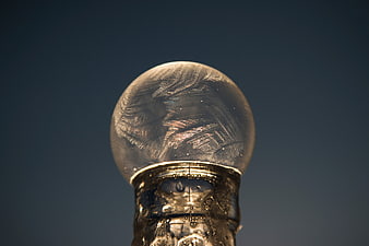 Close-up of ornate silver snow globe with intricate glass patterns
