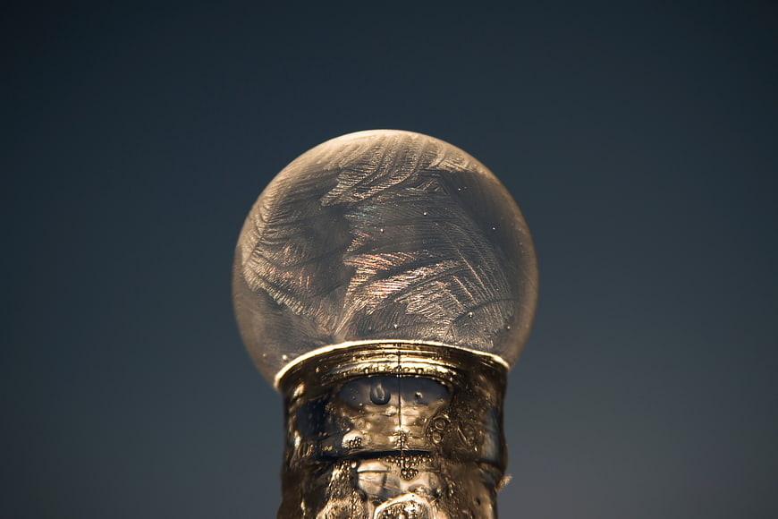 Close-up of ornate silver snow globe with intricate glass patterns