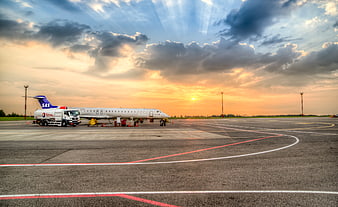 SAS Airplane Refueling on Airport Tarmac at Sunset