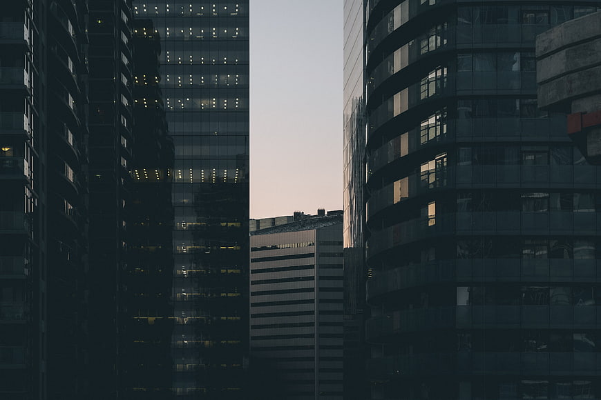 Modern Glass Skyscrapers at Dusk with Lit Windows
