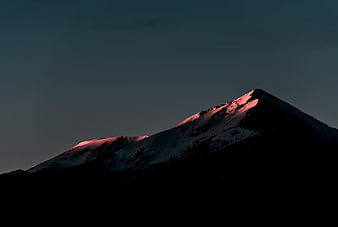 Snowy Mountain Peak with Pink Alpenglow at Dusk