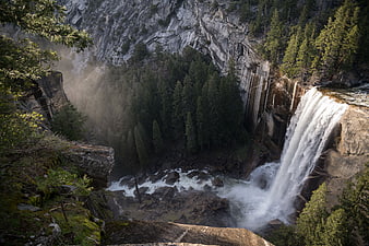 Majestic Yosemite Waterfall Cascading Through Granite Cliffs and Forest