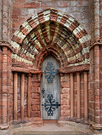 Ornate Gothic Archway with Weathered Wooden Door