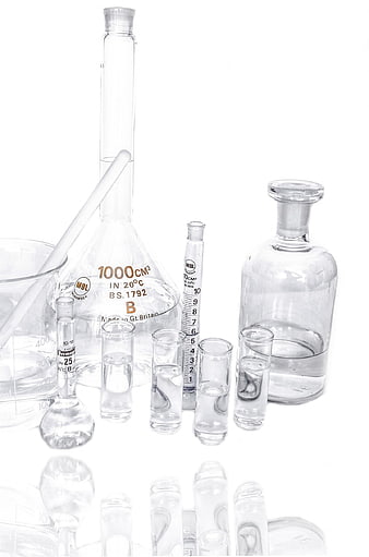 Laboratory Glassware Arrangement Including Beakers, Flasks, And Test Tubes On White Background