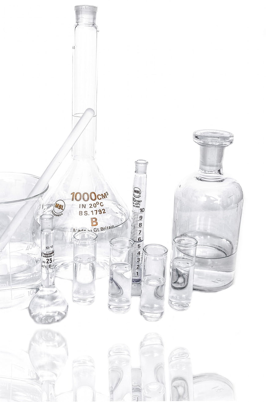 Laboratory Glassware Arrangement Including Beakers, Flasks, And Test Tubes On White Background