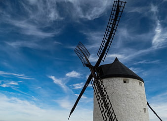 Traditional White Windmill Against Blue Sky with Clouds