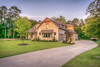 Luxury Stone House with Driveway at Dusk