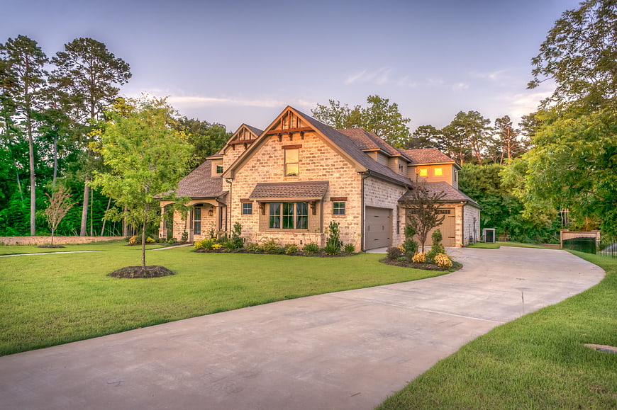 Luxury Stone House with Driveway at Dusk